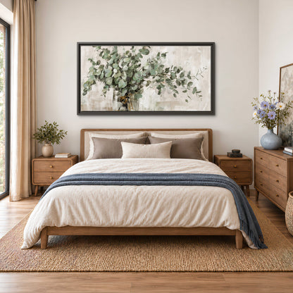 Soft sage eucalyptus leaves and pale stems on a warm cream background single framed canvas wall art styled in an interior