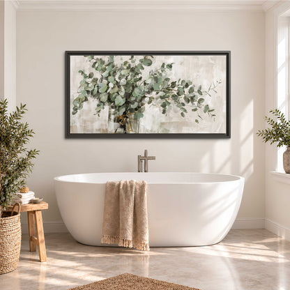 Soft sage eucalyptus leaves and pale stems on a warm cream background single framed canvas wall art styled in an interior