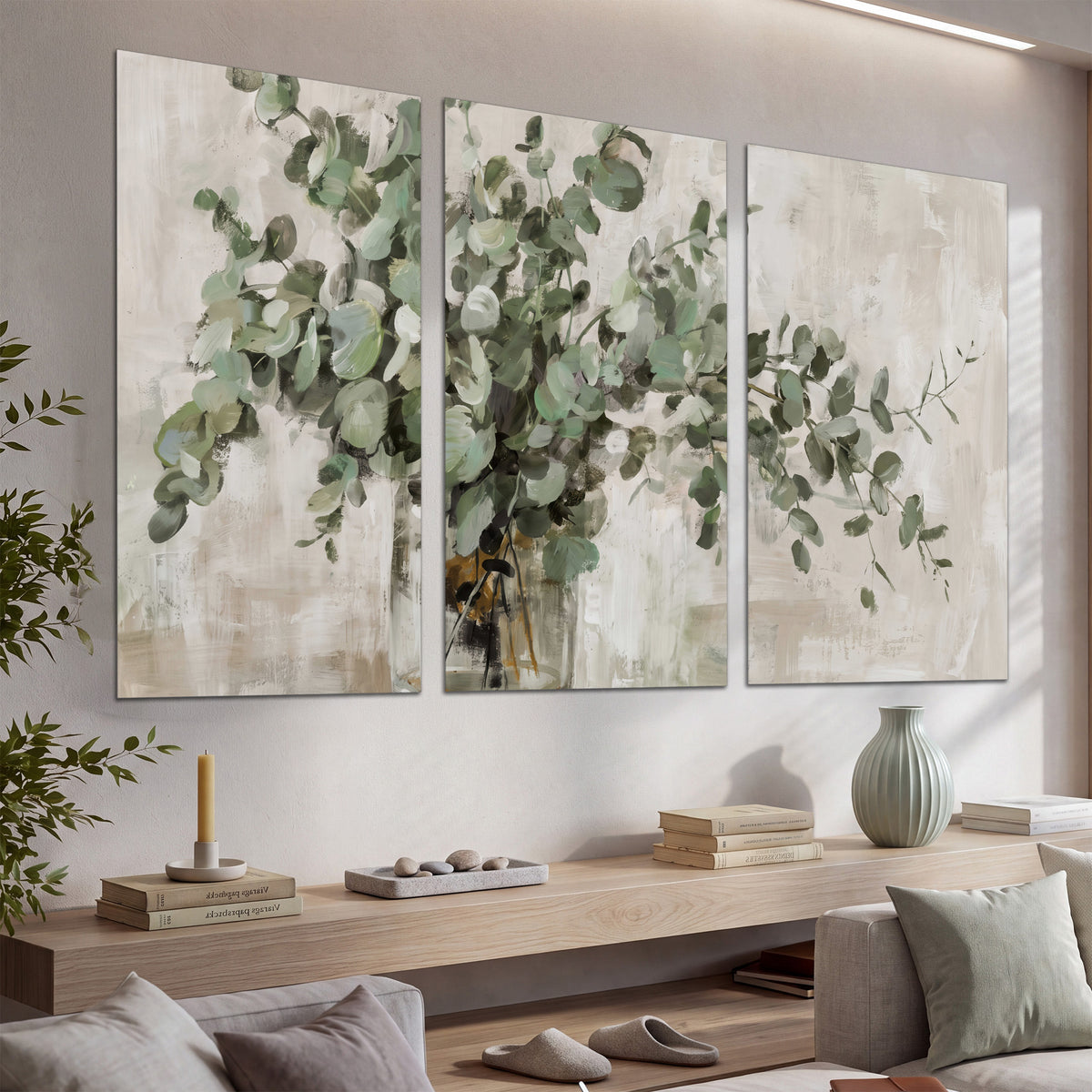 Soft sage eucalyptus leaves and pale stems on a warm cream background set of 3 poster prints displayed in a console