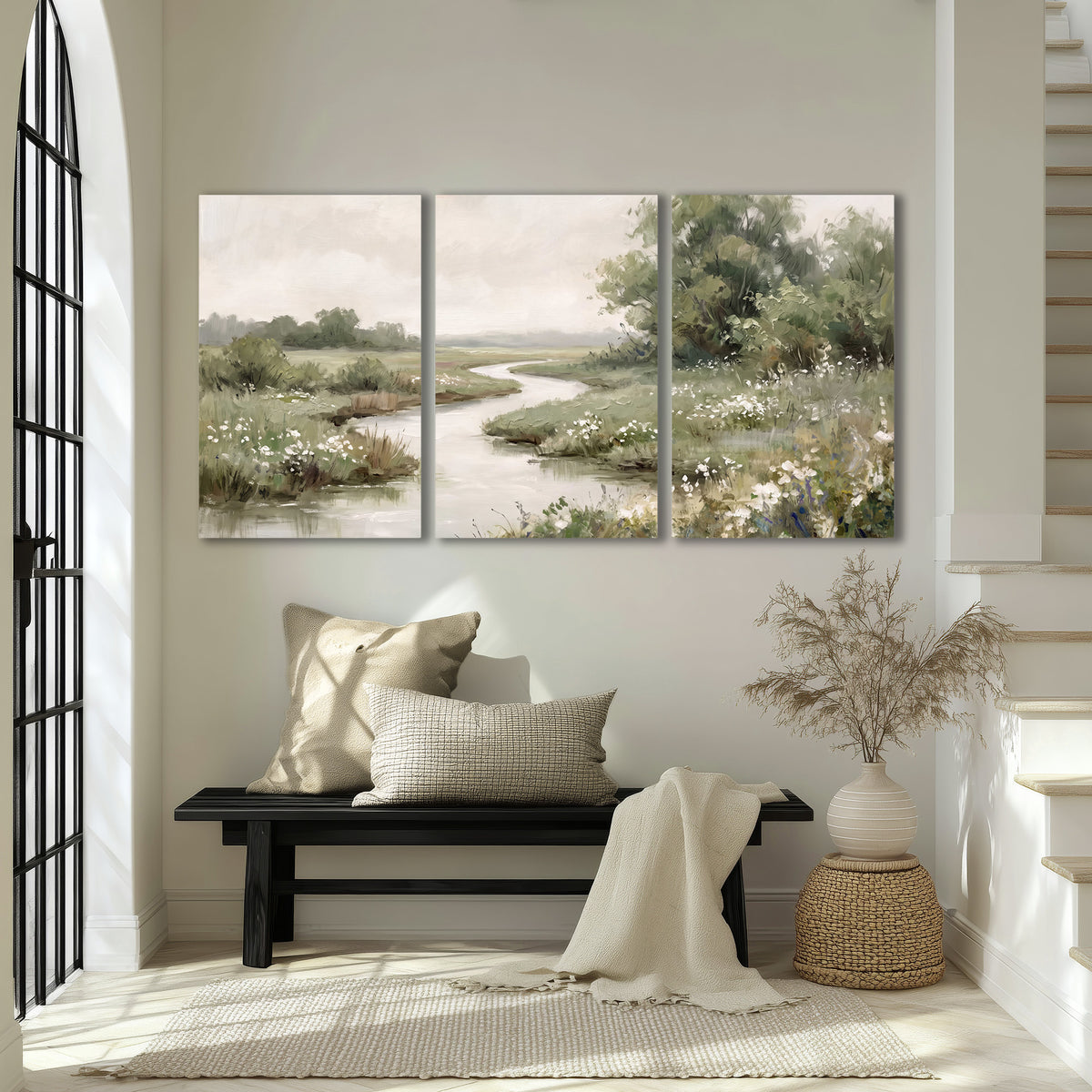 A narrow winding stream through quiet green meadows and trees 3 piece canvas wall art displayed in a entryway
