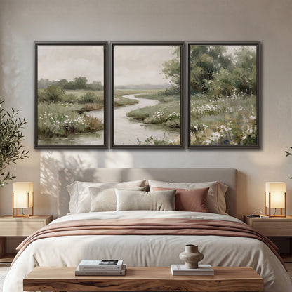 A narrow winding stream through quiet green meadows and trees 3 piece framed canvas wall art displayed in a bedroom