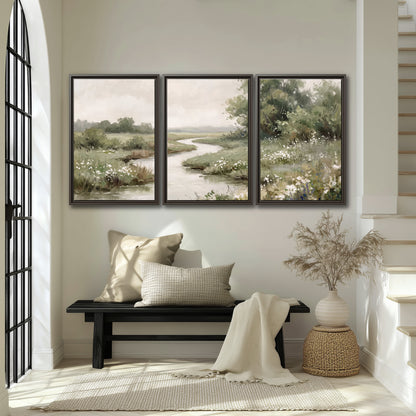 A narrow winding stream through quiet green meadows and trees 3 piece framed canvas wall art displayed in a entryway