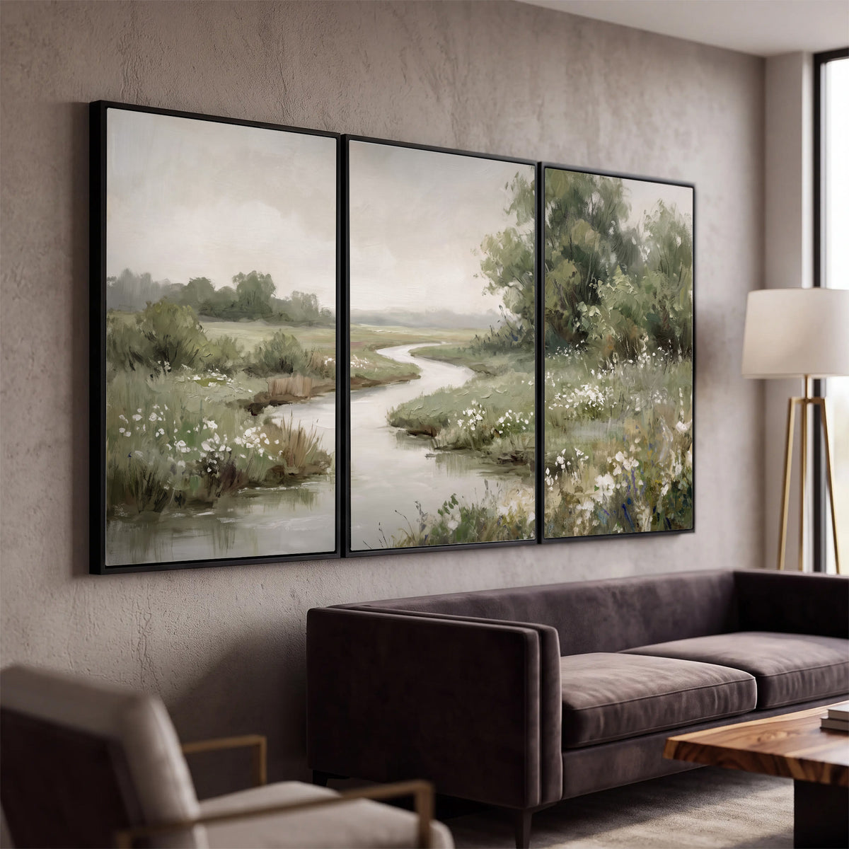 A narrow winding stream through quiet green meadows and trees 3 piece framed canvas wall art displayed in a modern living room