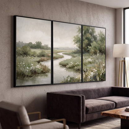 A narrow winding stream through quiet green meadows and trees 3 piece framed canvas wall art displayed in a modern living room