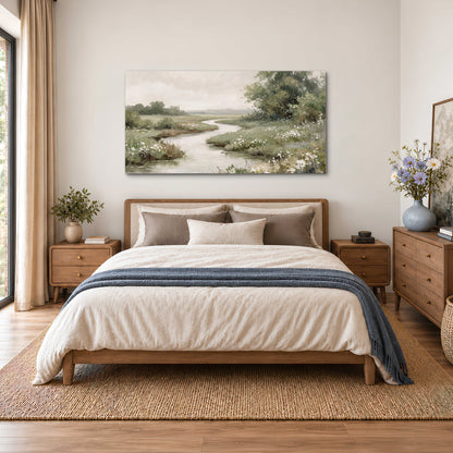 A narrow winding stream through quiet green meadows and trees single canvas wall art styled in an interior