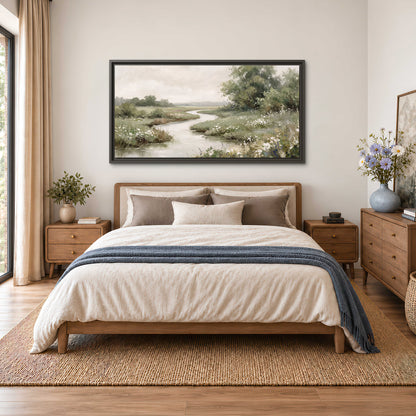 A narrow winding stream through quiet green meadows and trees single framed canvas wall art styled in an interior