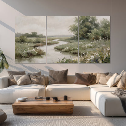 A narrow winding stream through quiet green meadows and trees set of 3 poster prints displayed in a living room