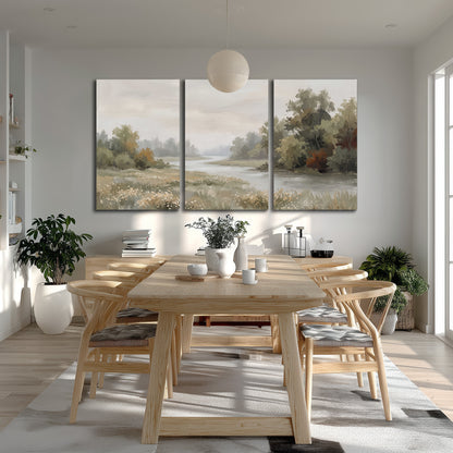 A broad pale river bordered by green trees and small meadow flowers 3 piece canvas wall art room and product view
