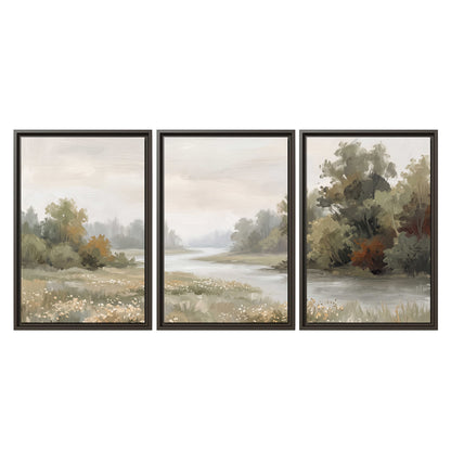A broad pale river bordered by green trees and small meadow flowers 3 piece framed canvas wall art viewed straight on