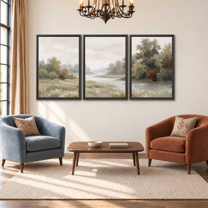 A broad pale river bordered by green trees and small meadow flowers 3 piece framed canvas wall art styled in an interior
