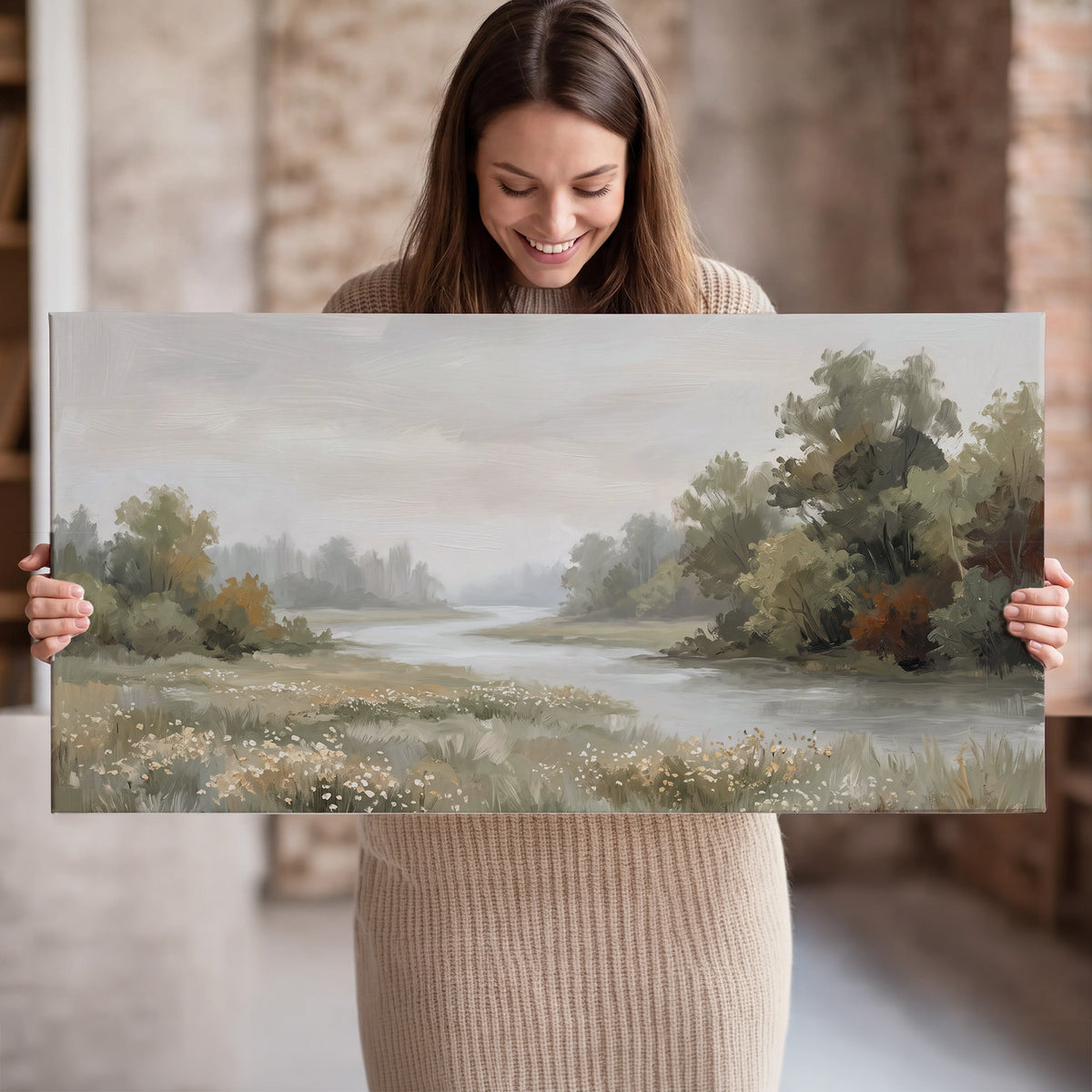 A broad pale river bordered by green trees and small meadow flowers single canvas wall art held in hands