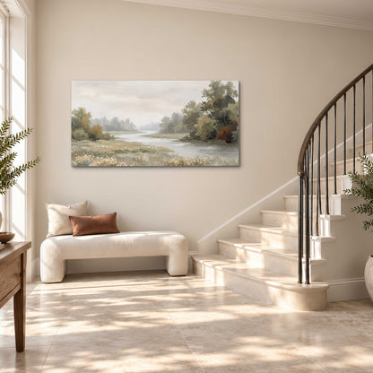 A broad pale river bordered by green trees and small meadow flowers single canvas wall art styled in an interior