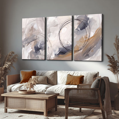 Expressive gray and cream abstract forms with fine gold-colored circular lines 3 piece canvas wall art displayed in a rustic living room