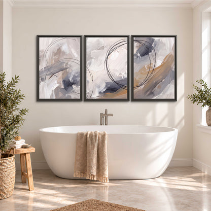 Expressive gray and cream abstract forms with fine gold-colored circular lines 3 piece framed canvas wall art styled in an interior