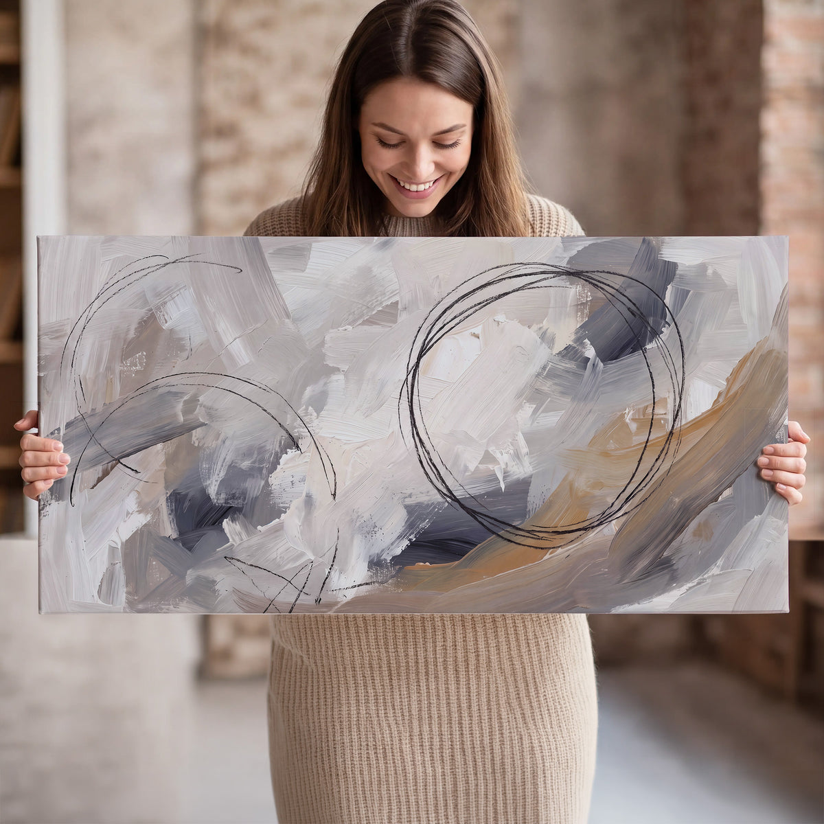 Expressive gray and cream abstract forms with fine gold-colored circular lines single canvas wall art held in hands