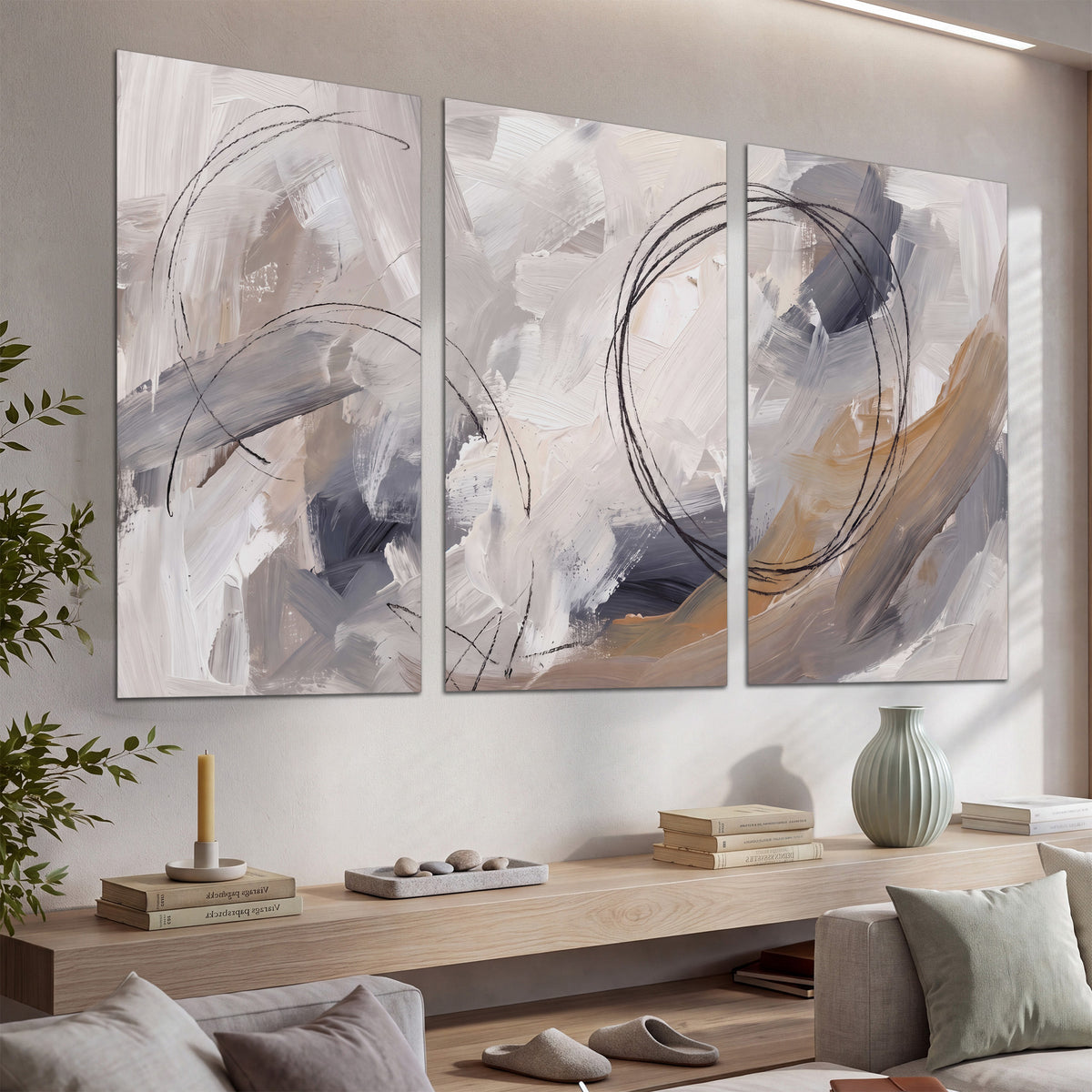 Expressive gray and cream abstract forms with fine gold-colored circular lines set of 3 poster prints displayed in a console