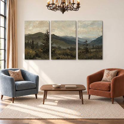 Layered mountain ridges and dark evergreen trees beneath a muted cloudy sky 3 piece canvas wall art styled in an interior