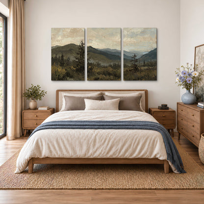 Layered mountain ridges and dark evergreen trees beneath a muted cloudy sky 3 piece canvas wall art styled in an interior