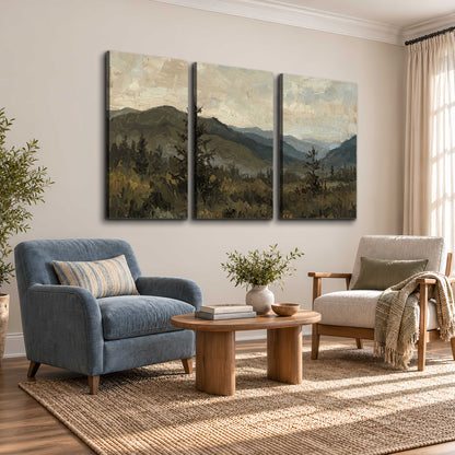 Layered mountain ridges and dark evergreen trees beneath a muted cloudy sky 3 piece canvas wall art styled in an interior