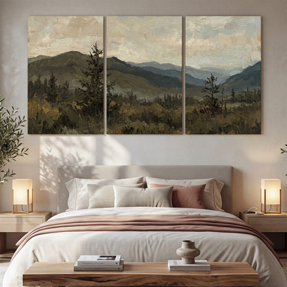 Layered mountain ridges and dark evergreen trees beneath a muted cloudy sky 3 piece canvas wall art displayed in a bedroom