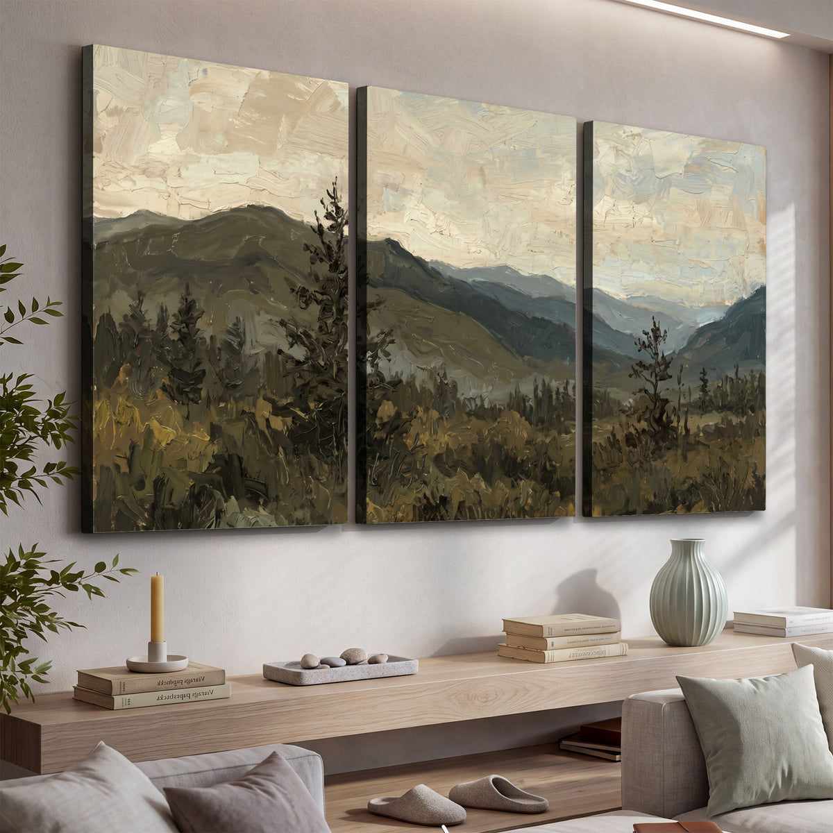 Layered mountain ridges and dark evergreen trees beneath a muted cloudy sky 3 piece canvas wall art displayed in a console