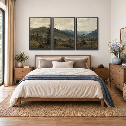Layered mountain ridges and dark evergreen trees beneath a muted cloudy sky 3 piece framed canvas wall art styled in an interior