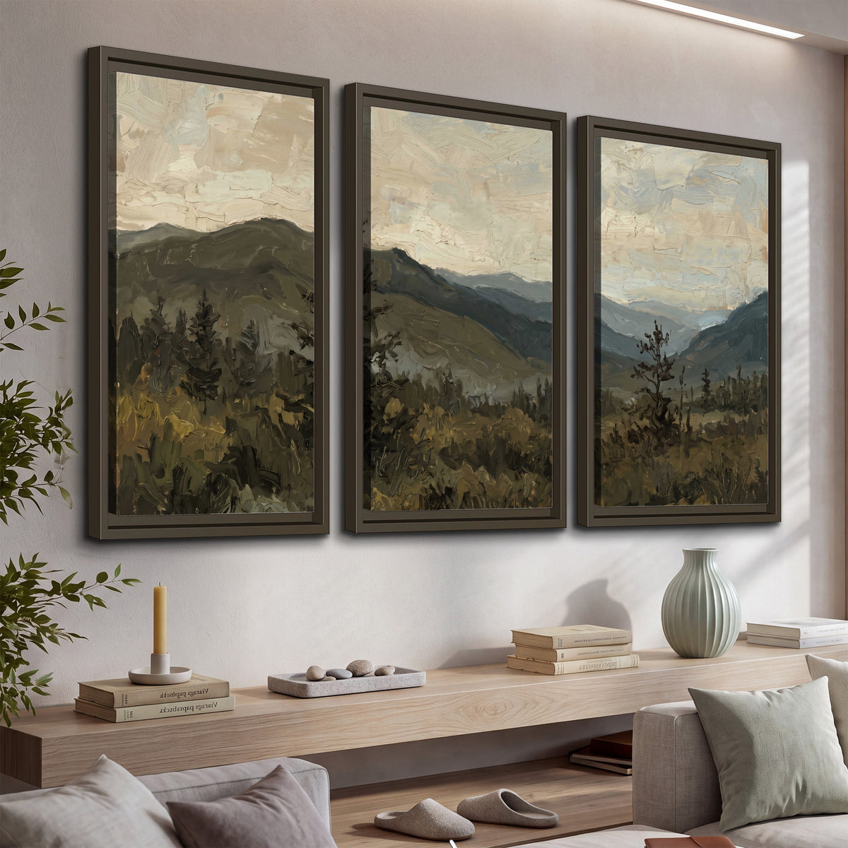 Layered mountain ridges and dark evergreen trees beneath a muted cloudy sky 3 piece framed canvas wall art displayed in a console