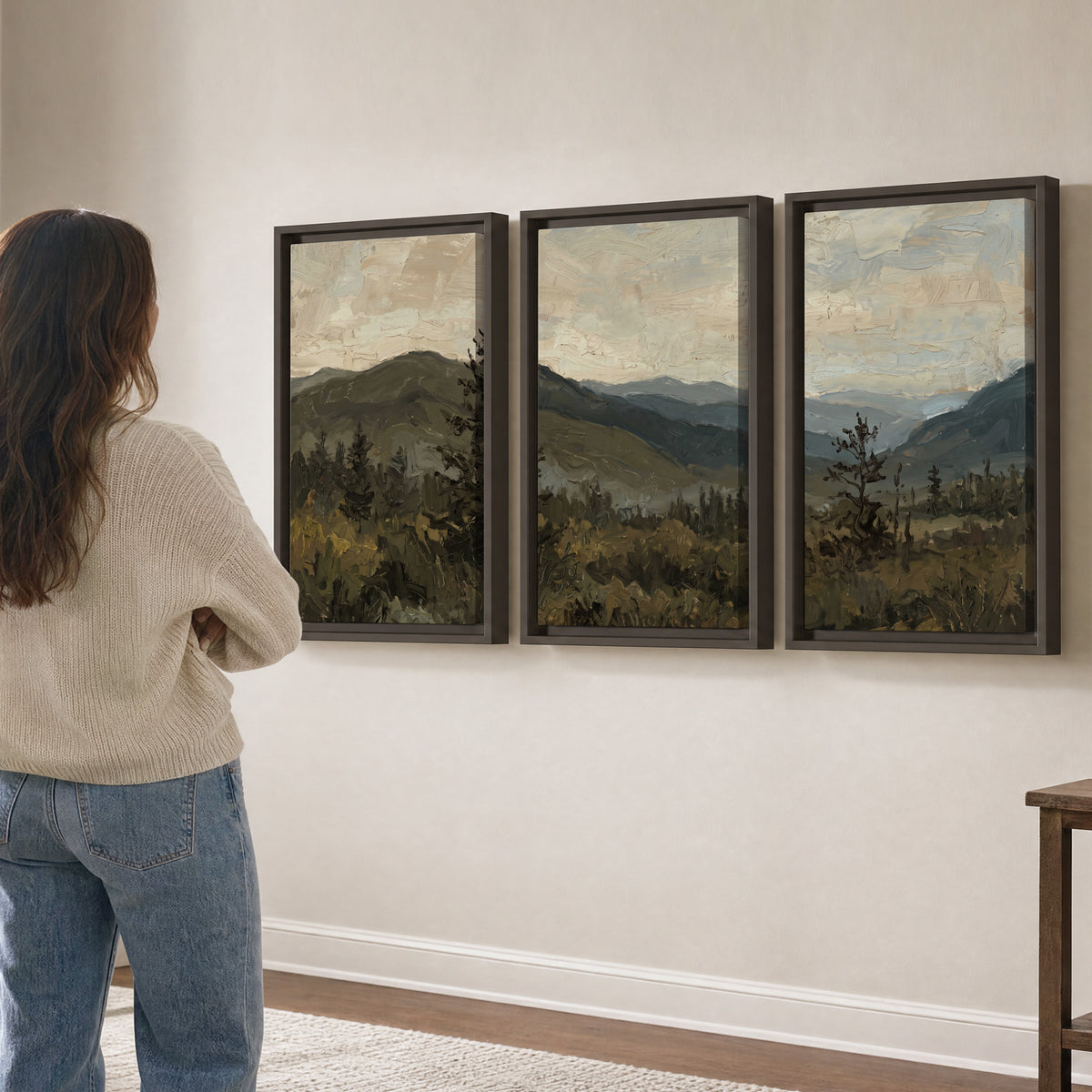 Layered mountain ridges and dark evergreen trees beneath a muted cloudy sky 3 piece framed canvas wall art three panel arrangement on a wall