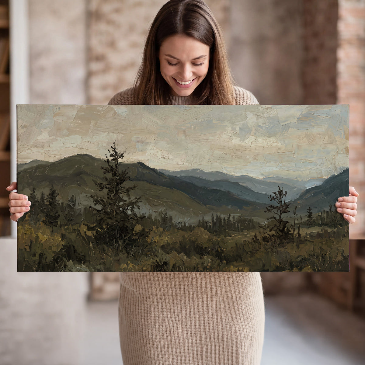 Layered mountain ridges and dark evergreen trees beneath a muted cloudy sky single canvas wall art held in hands