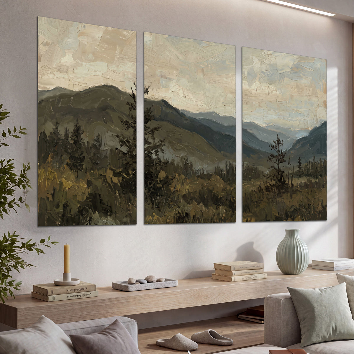 Layered mountain ridges and dark evergreen trees beneath a muted cloudy sky set of 3 poster prints displayed in a console