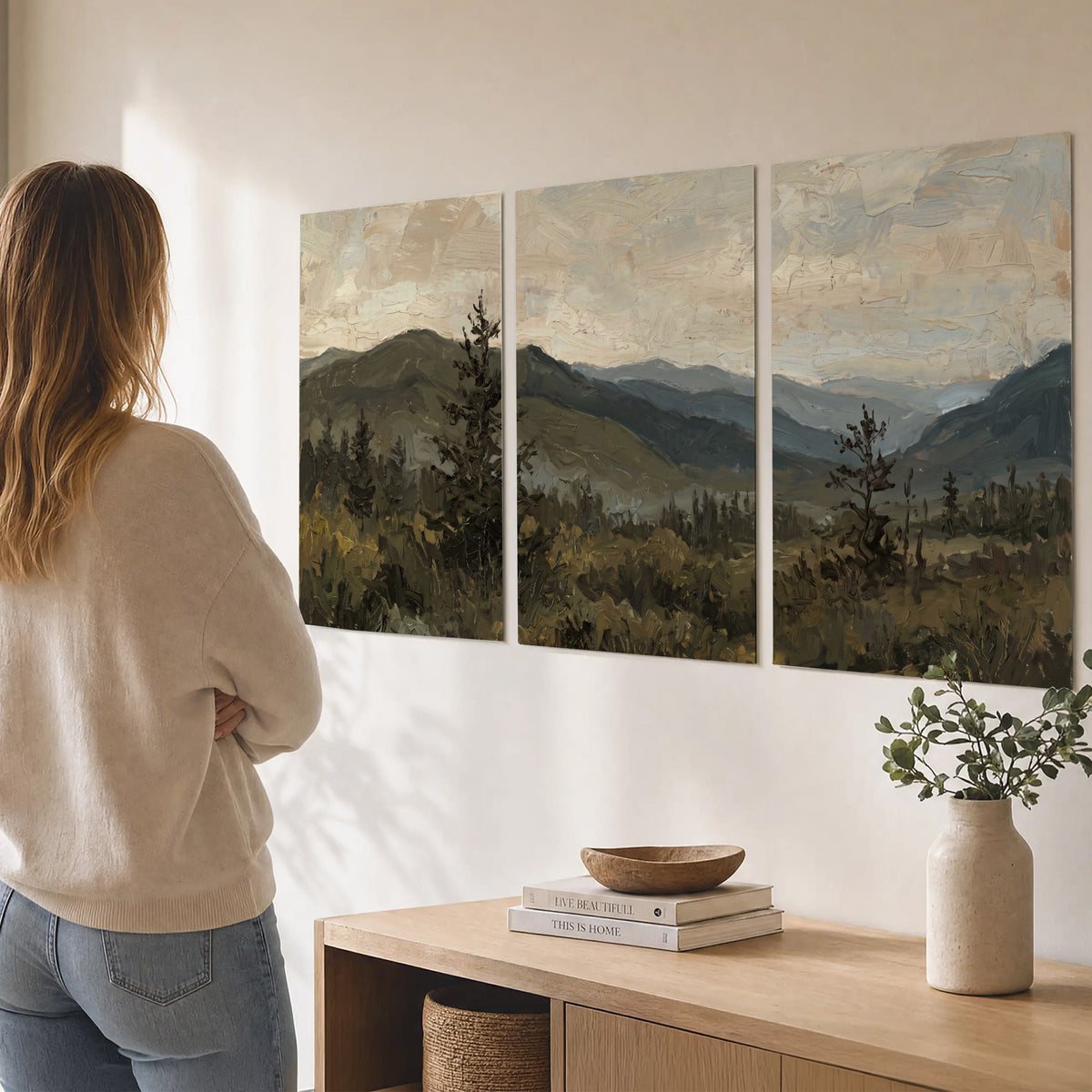 Layered mountain ridges and dark evergreen trees beneath a muted cloudy sky set of 3 poster prints three panel arrangement on a wall