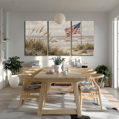 An American flag above coastal grasses beside a quiet sandy beach 3 piece canvas wall art room and product view