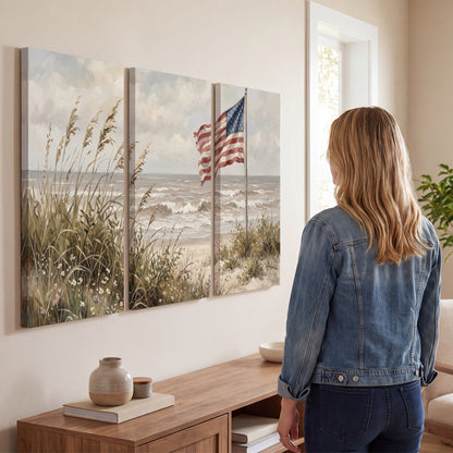 An American flag above coastal grasses beside a quiet sandy beach 3 piece canvas wall art three panel arrangement on a wall