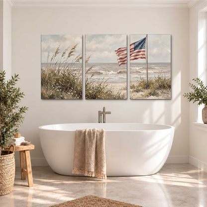 An American flag above coastal grasses beside a quiet sandy beach 3 piece canvas wall art styled in an interior