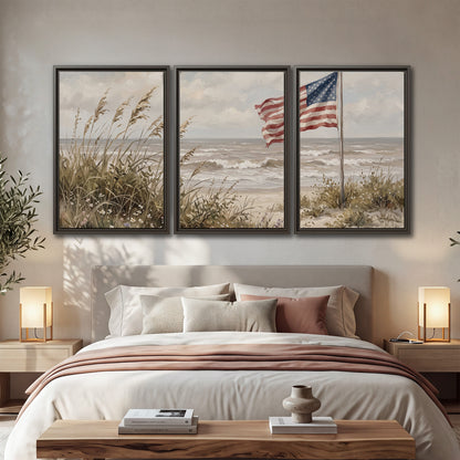 An American flag above coastal grasses beside a quiet sandy beach 3 piece framed canvas wall art displayed in a bedroom