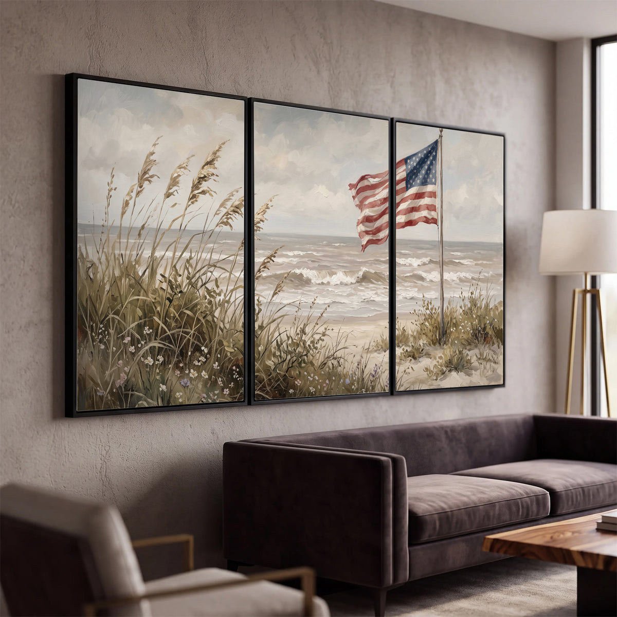 An American flag above coastal grasses beside a quiet sandy beach 3 piece framed canvas wall art displayed in a modern living room