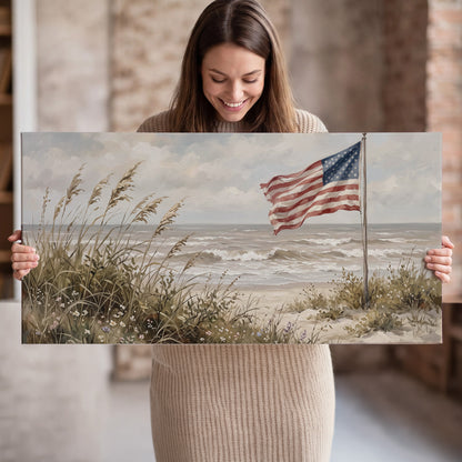 An American flag above coastal grasses beside a quiet sandy beach single canvas wall art held in hands