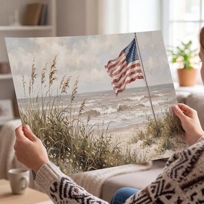 An American flag above coastal grasses beside a quiet sandy beach single poster print held in hands