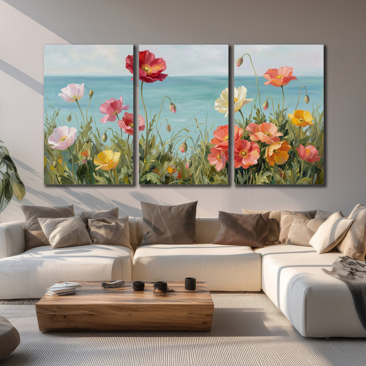 Colorful red, peach and yellow flowers beside a turquoise sea 3 piece canvas wall art displayed in a living room