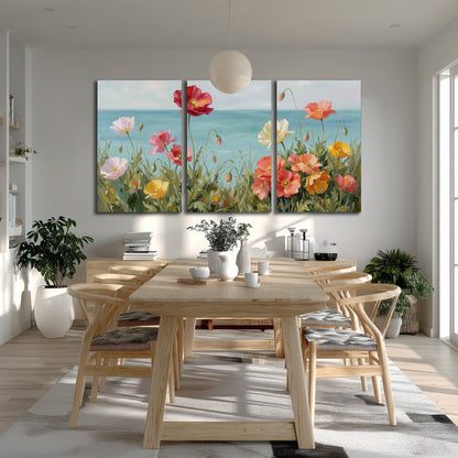 Colorful red, peach and yellow flowers beside a turquoise sea 3 piece canvas wall art room and product view