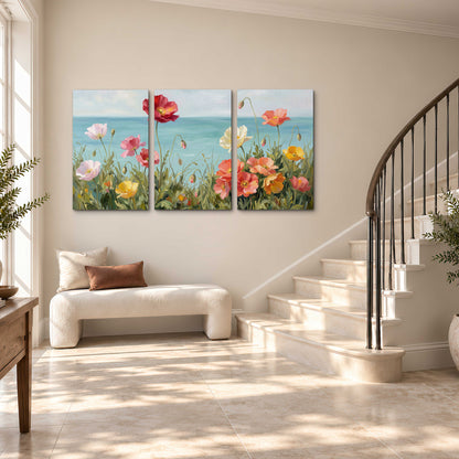 Colorful red, peach and yellow flowers beside a turquoise sea 3 piece canvas wall art styled in an interior