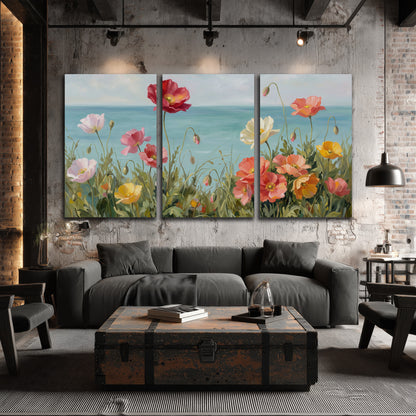 Colorful red, peach and yellow flowers beside a turquoise sea 3 piece canvas wall art displayed in a industrial room