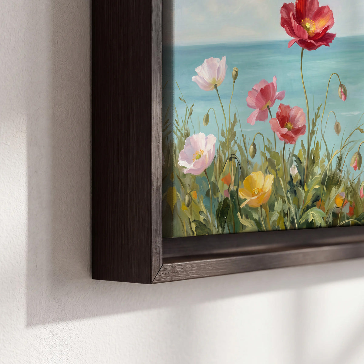 Colorful red, peach and yellow flowers beside a turquoise sea 3 piece framed canvas wall art material and edge close up