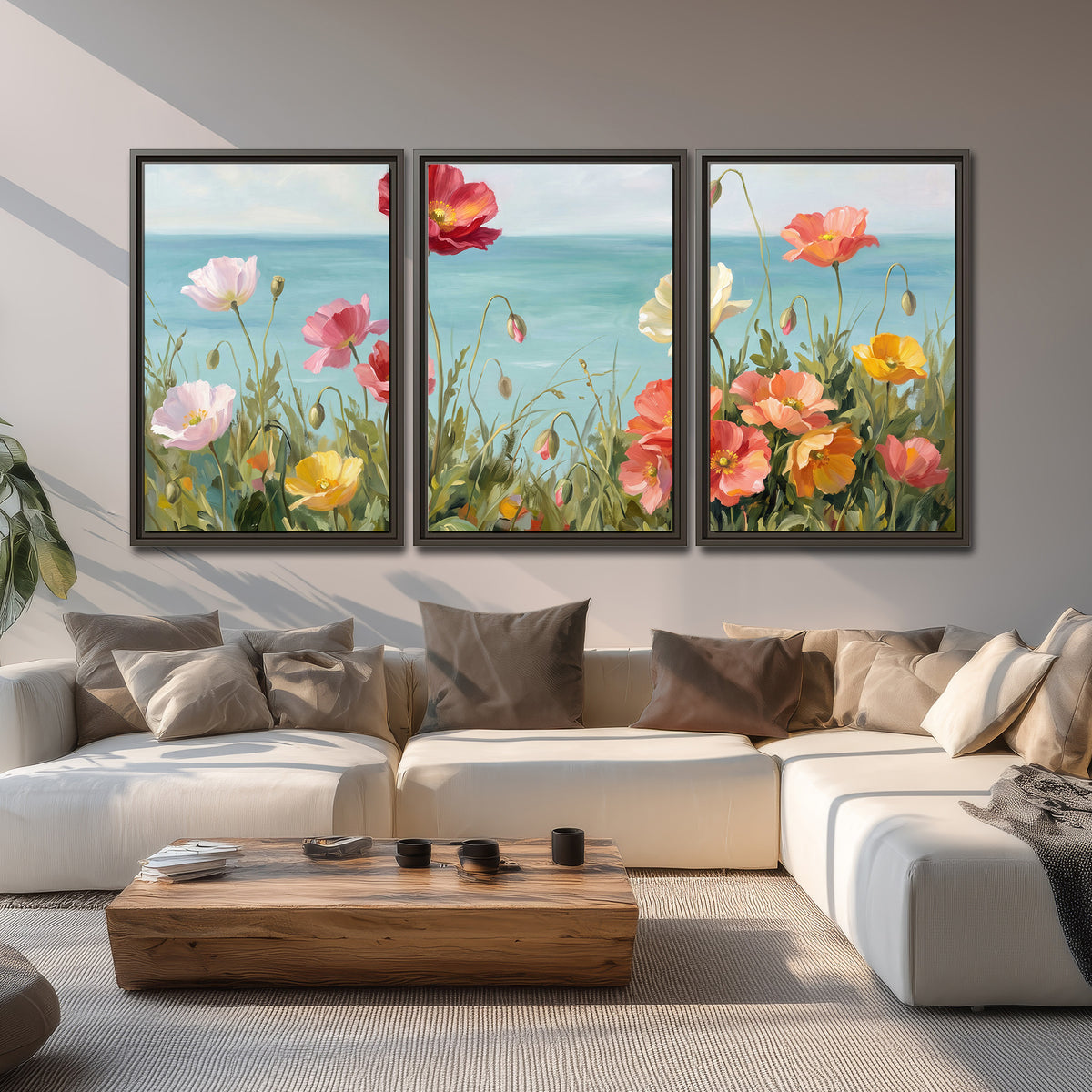 Colorful red, peach and yellow flowers beside a turquoise sea 3 piece framed canvas wall art displayed in a living room