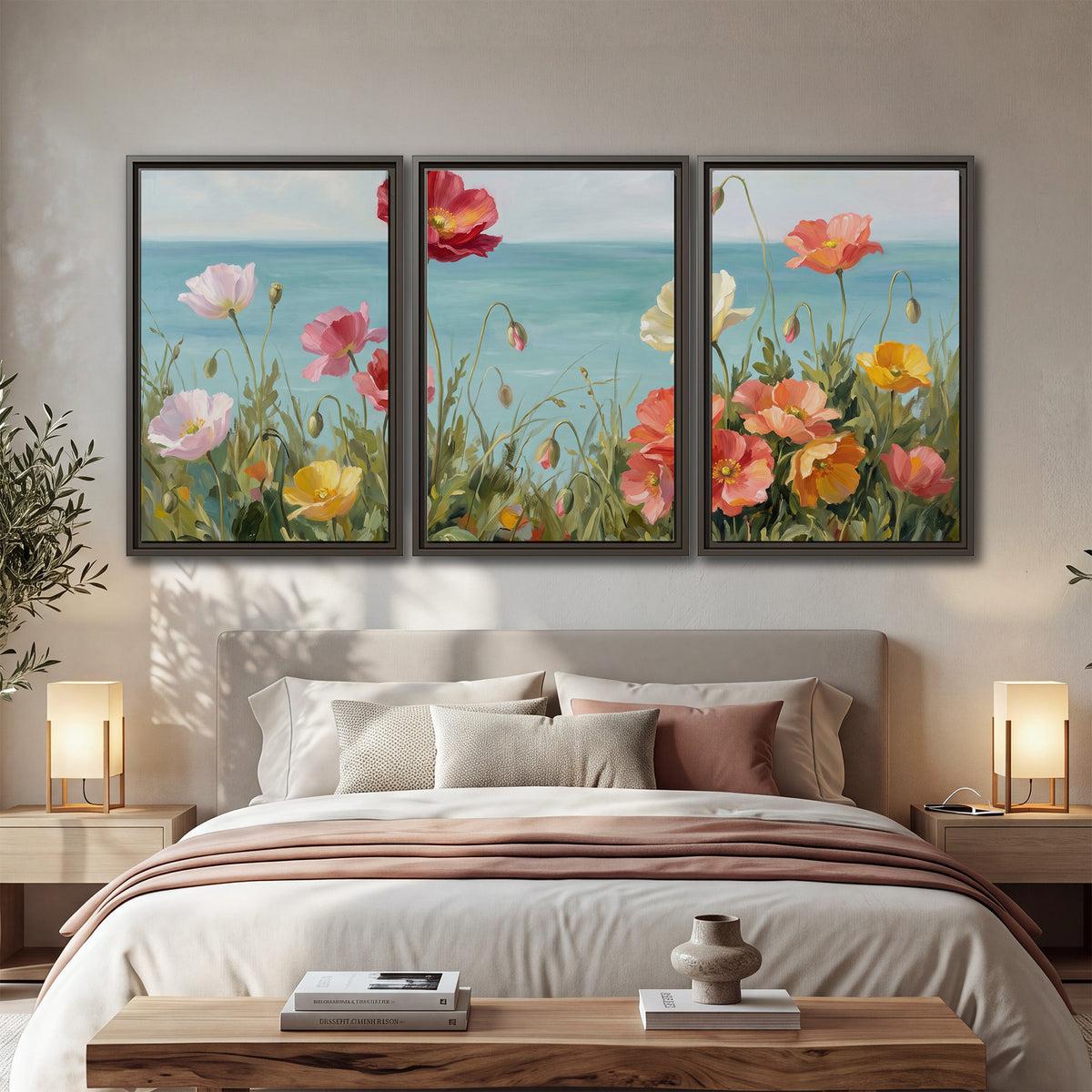 Colorful red, peach and yellow flowers beside a turquoise sea 3 piece framed canvas wall art displayed in a bedroom
