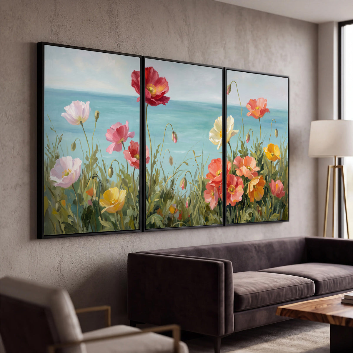 Colorful red, peach and yellow flowers beside a turquoise sea 3 piece framed canvas wall art displayed in a modern living room
