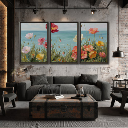 Colorful red, peach and yellow flowers beside a turquoise sea 3 piece framed canvas wall art displayed in a industrial room