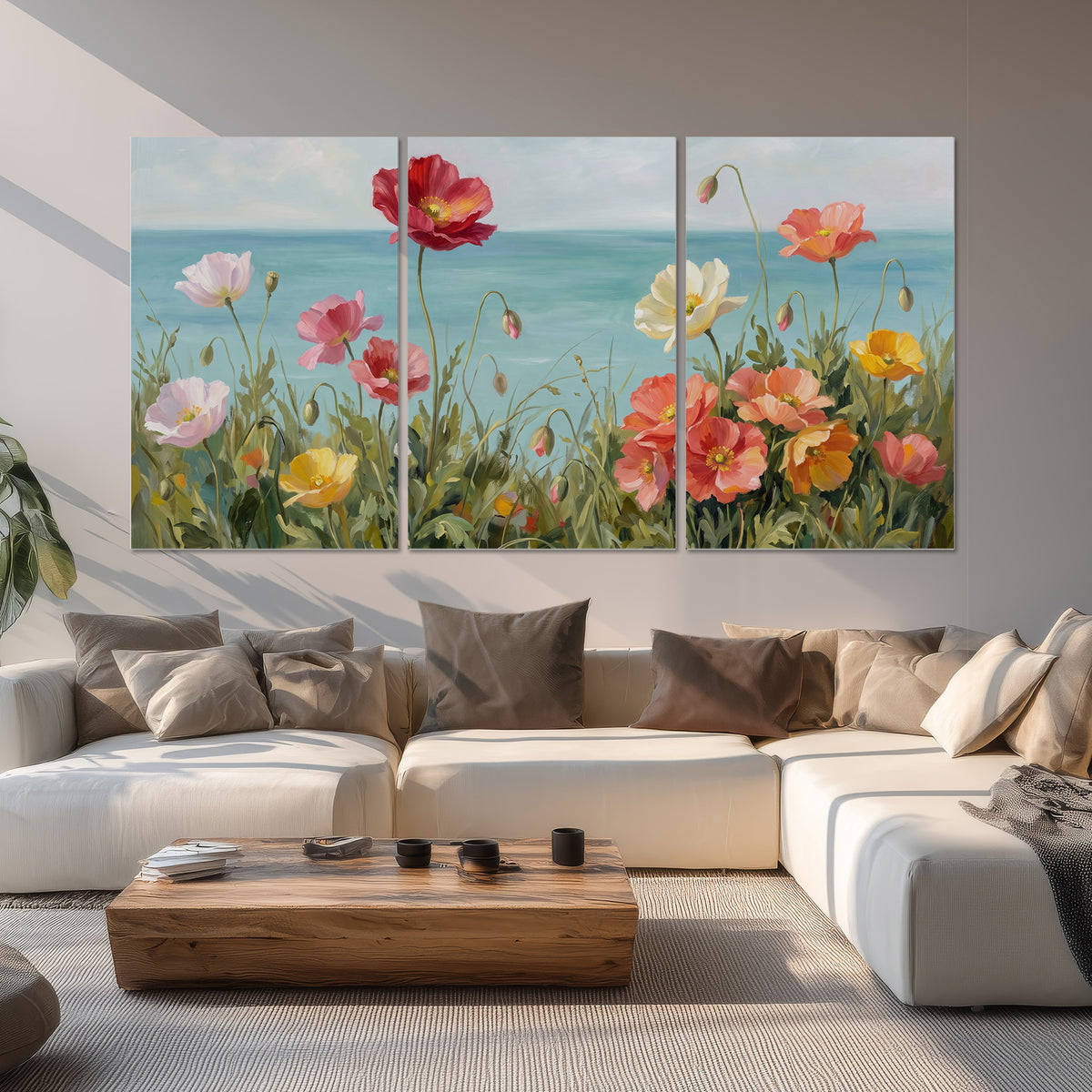Colorful red, peach and yellow flowers beside a turquoise sea set of 3 poster prints displayed in a living room