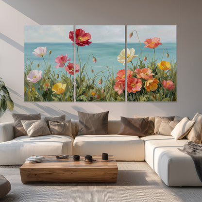 Colorful red, peach and yellow flowers beside a turquoise sea set of 3 poster prints displayed in a living room