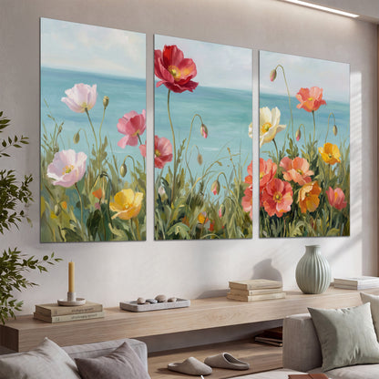 Colorful red, peach and yellow flowers beside a turquoise sea set of 3 poster prints displayed in a console